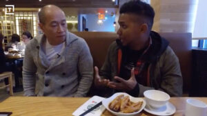 Tim Ho Wan - Picture of customers talking in a restaurant.